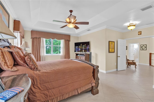 bedroom with light tile patterned floors, baseboards, a raised ceiling, and crown molding