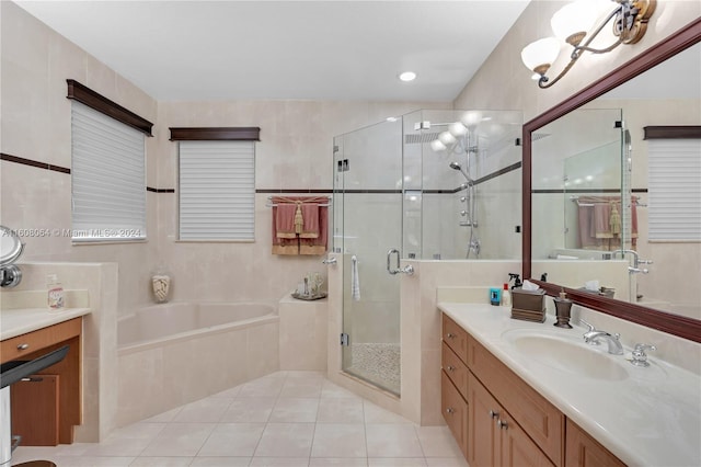 full bath with tile walls, a stall shower, vanity, tile patterned flooring, and a bath