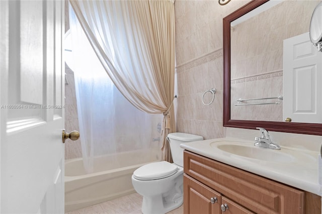 full bathroom featuring toilet, vanity, tile walls, tile patterned floors, and washtub / shower combination