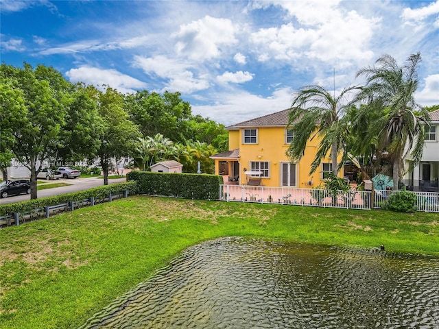 view of home's community featuring fence private yard and a water view