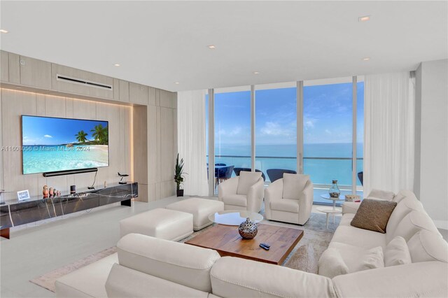 living room featuring a wall of windows and a water view