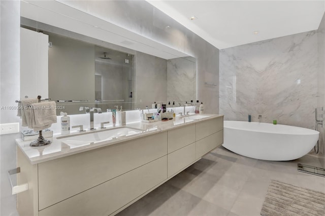 bathroom featuring tile floors, dual sinks, tile walls, and large vanity