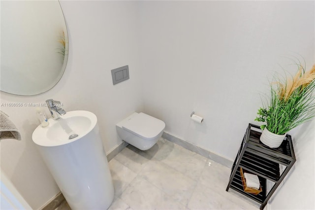 bathroom featuring sink, tile flooring, and toilet