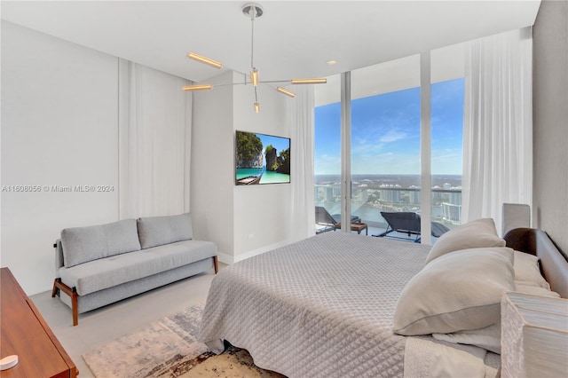 bedroom with a wall of windows and access to outside