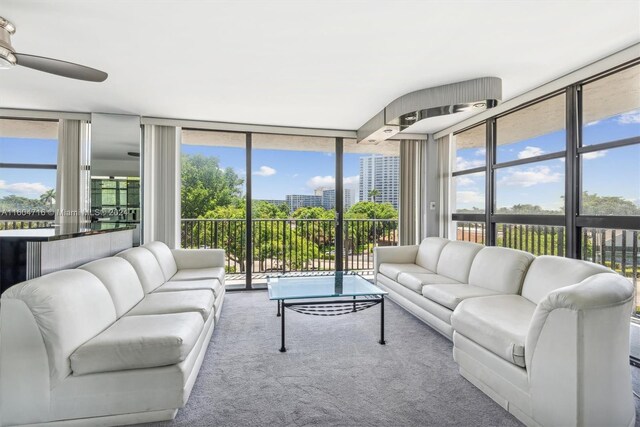 living room with carpet floors, expansive windows, and plenty of natural light