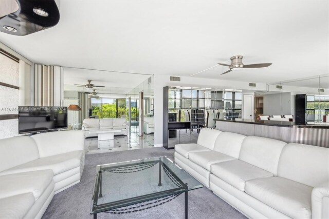 living room with a healthy amount of sunlight, ceiling fan, and tile floors