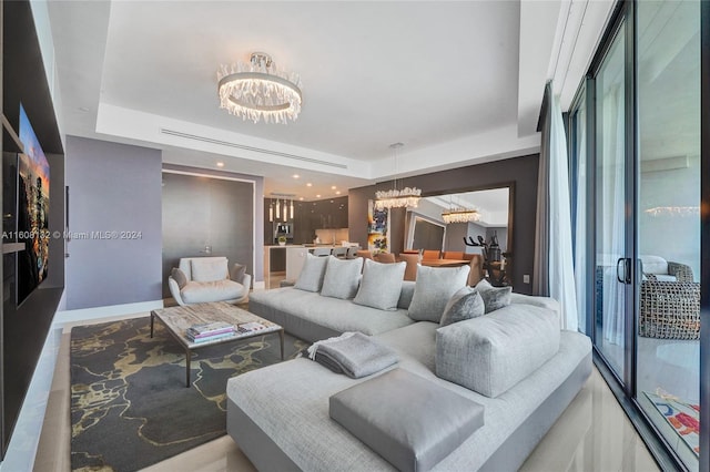 living room with a chandelier and a tray ceiling