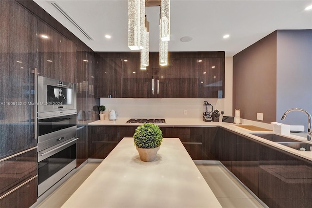 kitchen with light tile patterned floors, stainless steel appliances, and sink