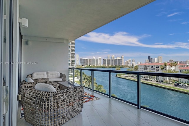 balcony featuring an outdoor living space and a water view