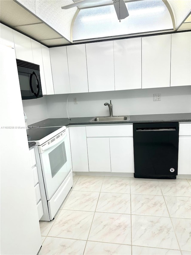 kitchen featuring light tile flooring, ceiling fan, white cabinetry, black appliances, and sink