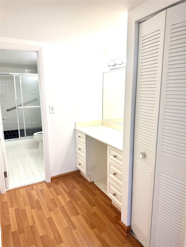 bathroom with tile floors, toilet, and vanity with extensive cabinet space