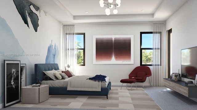 carpeted bedroom featuring a tray ceiling and a chandelier