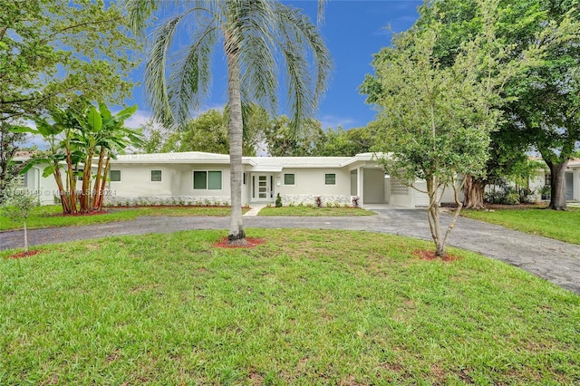 single story home featuring a front yard and a garage