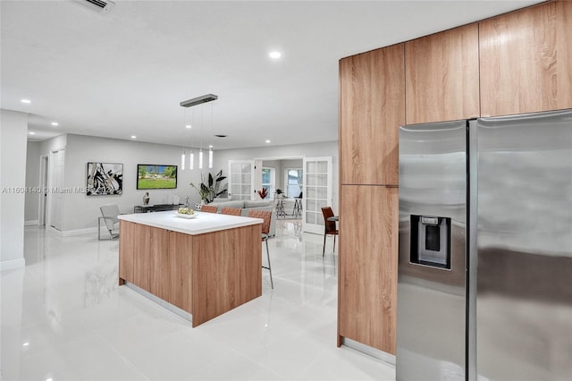 kitchen featuring a center island, french doors, hanging light fixtures, light tile patterned floors, and stainless steel fridge with ice dispenser