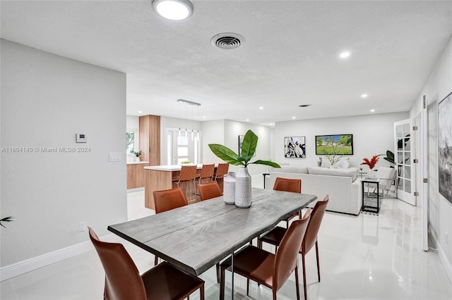 dining area with a textured ceiling