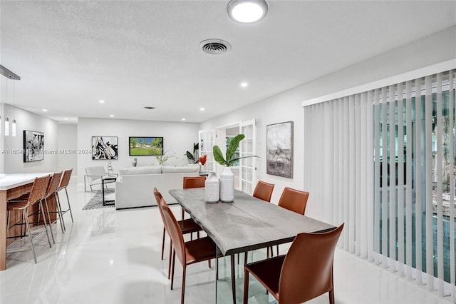 dining area featuring a textured ceiling