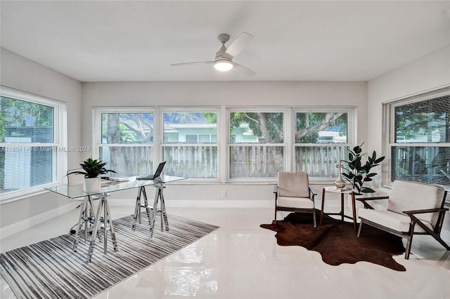 sunroom / solarium featuring ceiling fan and a healthy amount of sunlight