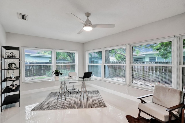 interior space with ceiling fan