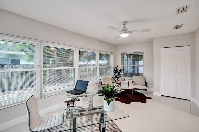 interior space with ceiling fan