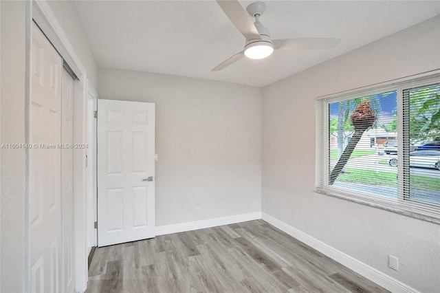 unfurnished bedroom with a closet, ceiling fan, and light hardwood / wood-style floors