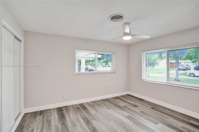 unfurnished bedroom with ceiling fan, a closet, and light hardwood / wood-style flooring