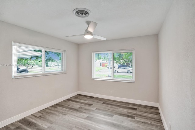 spare room featuring wood-type flooring and ceiling fan