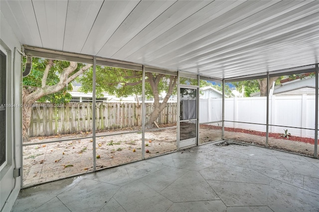 unfurnished sunroom featuring a wealth of natural light and wooden ceiling