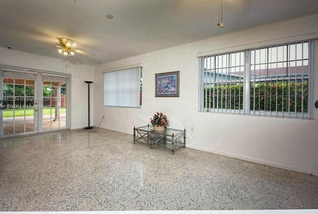 empty room with french doors and ceiling fan