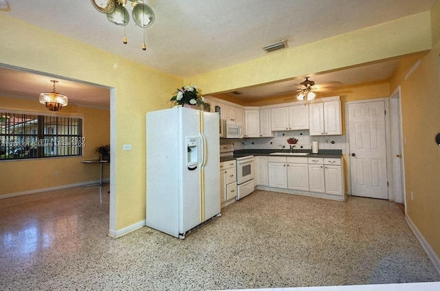 kitchen featuring white cabinetry, decorative light fixtures, white appliances, decorative backsplash, and ceiling fan with notable chandelier