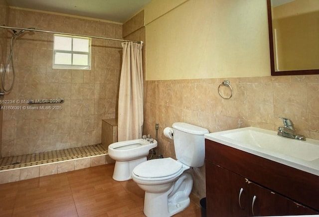 bathroom featuring a shower with curtain, a bidet, toilet, vanity, and tile walls