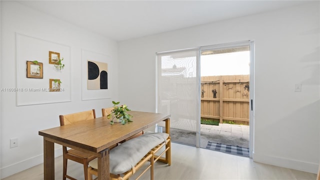 dining area with light hardwood / wood-style floors and a wealth of natural light