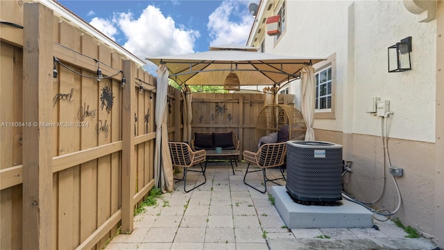 view of patio with central air condition unit and a gazebo