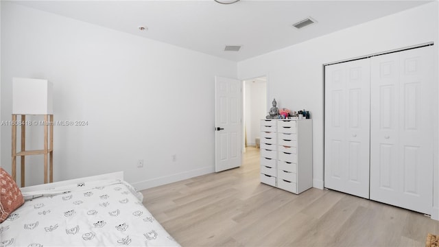 bedroom with a closet and light wood-type flooring