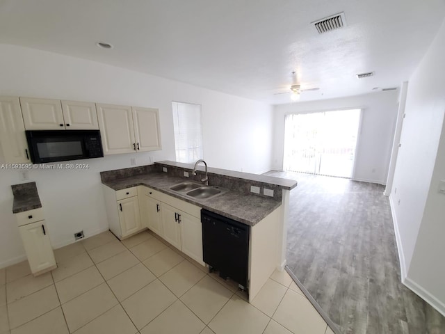 kitchen featuring kitchen peninsula, ceiling fan, sink, black appliances, and light tile patterned flooring