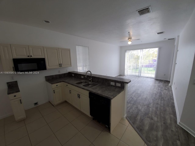 kitchen featuring ceiling fan, sink, kitchen peninsula, light tile patterned floors, and black appliances