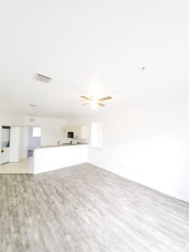 unfurnished living room with light hardwood / wood-style floors and ceiling fan