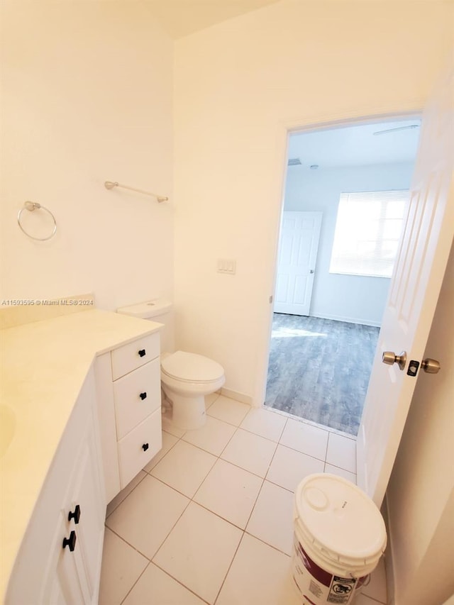 bathroom featuring tile patterned floors, vanity, and toilet