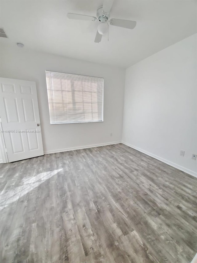 unfurnished bedroom with ceiling fan and wood-type flooring