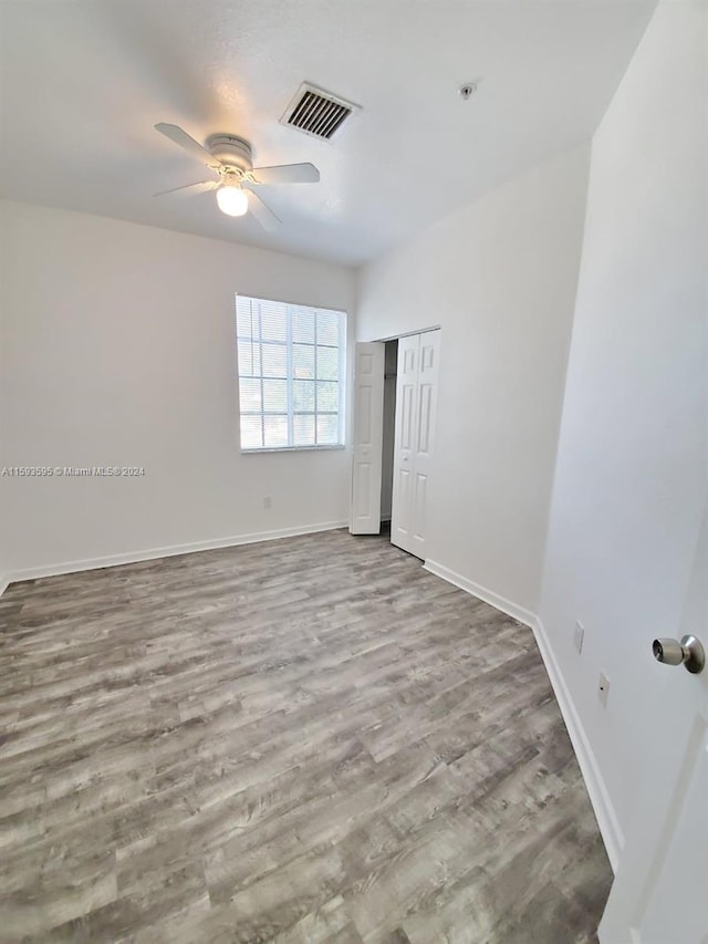 spare room with light hardwood / wood-style floors and ceiling fan