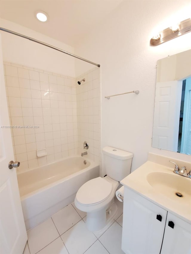 full bathroom featuring tile patterned flooring, vanity, tiled shower / bath combo, and toilet