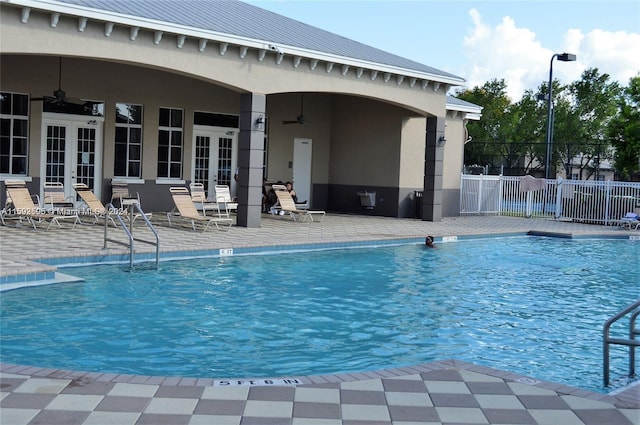 view of pool featuring french doors, a patio, and ceiling fan