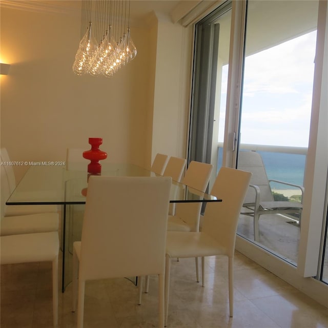 unfurnished dining area with a wealth of natural light, a water view, and a chandelier