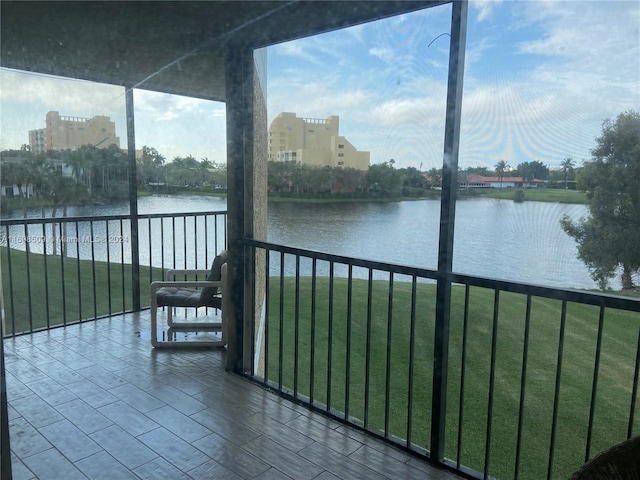 unfurnished sunroom with a water view and a wealth of natural light