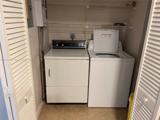 laundry area featuring light tile patterned floors, electric panel, and independent washer and dryer