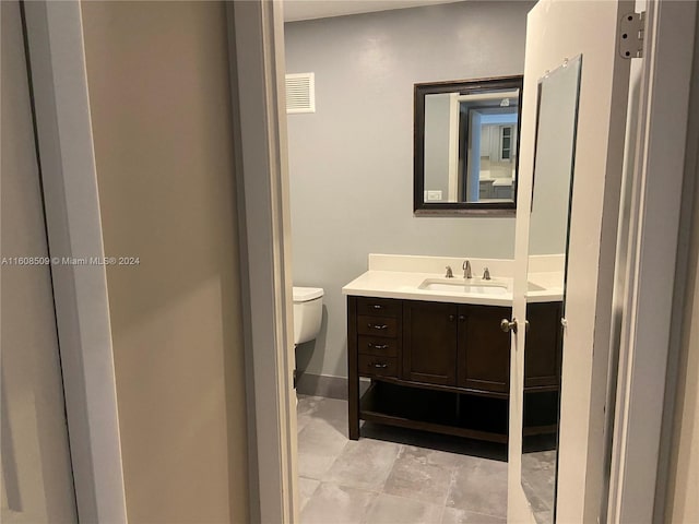 bathroom featuring vanity and toilet