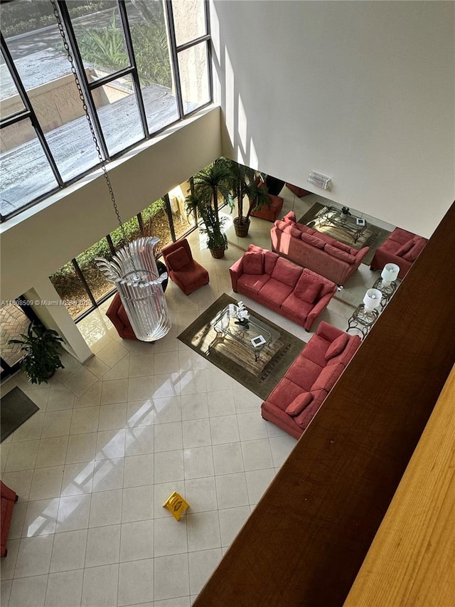 tiled living room featuring a high ceiling