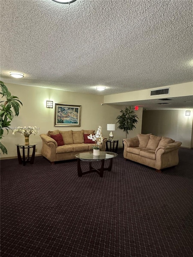 carpeted living room featuring a textured ceiling