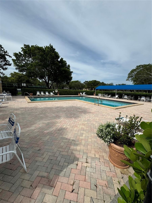 view of swimming pool featuring a patio area