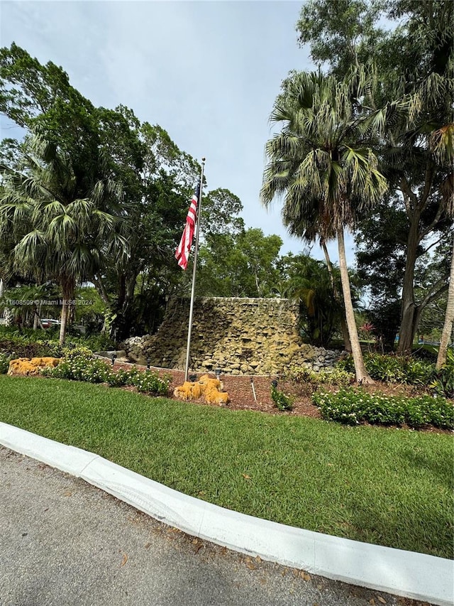 community / neighborhood sign with a lawn