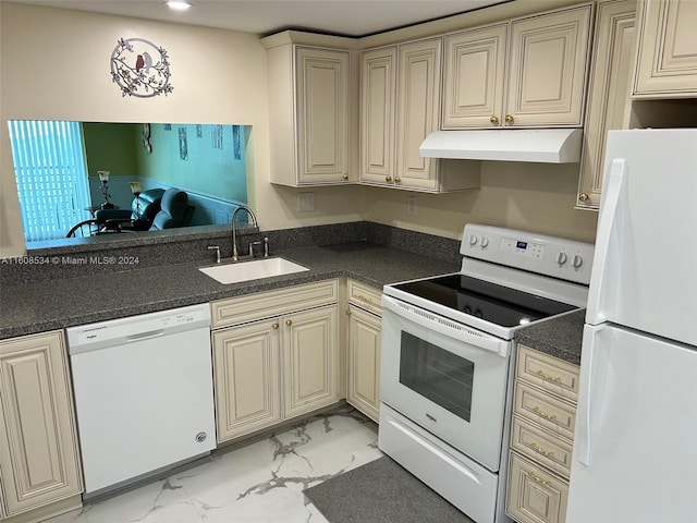 kitchen with sink, cream cabinetry, and white appliances